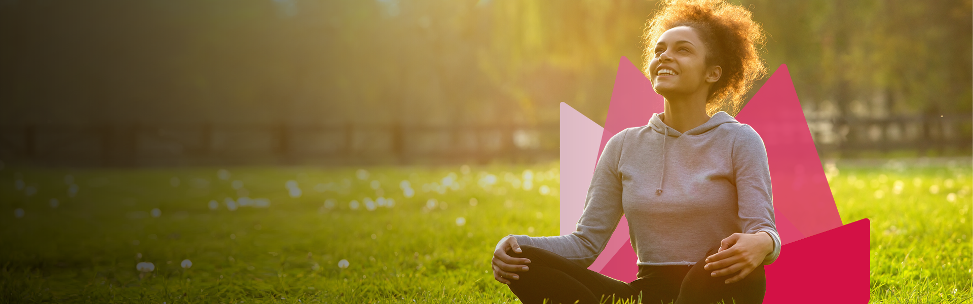 Woman smiling while sitting on ground in park
